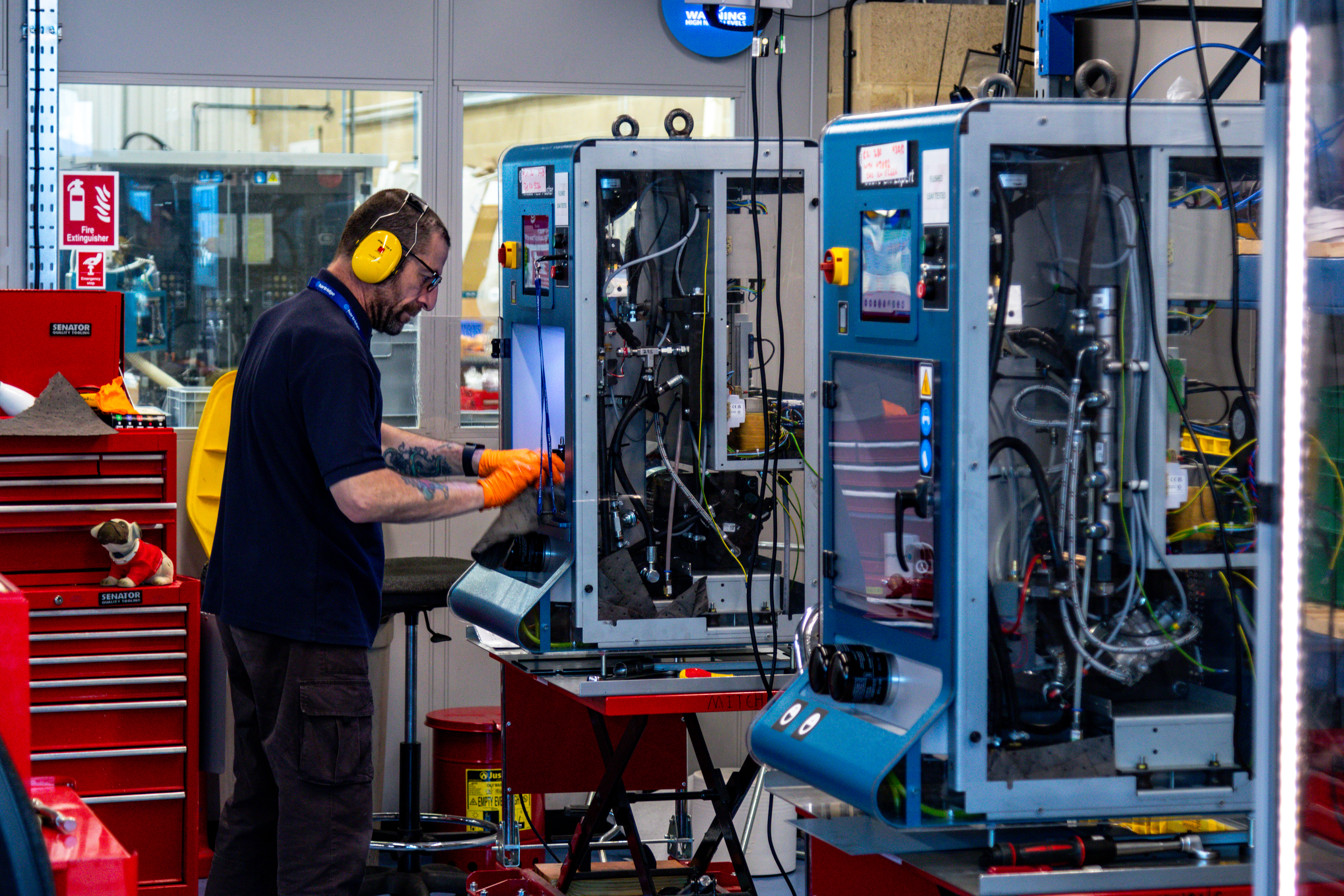 technician working on injector test bench in factory